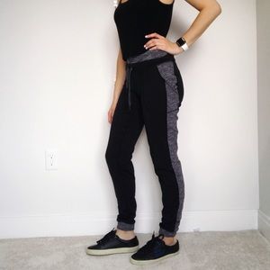 grey joggers with black stripe